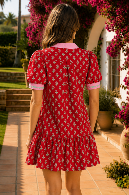 Red floral mini dress with pink collared neckline, mint scalloped trim, short puff sleeves, and a ruffled drop-waist hem