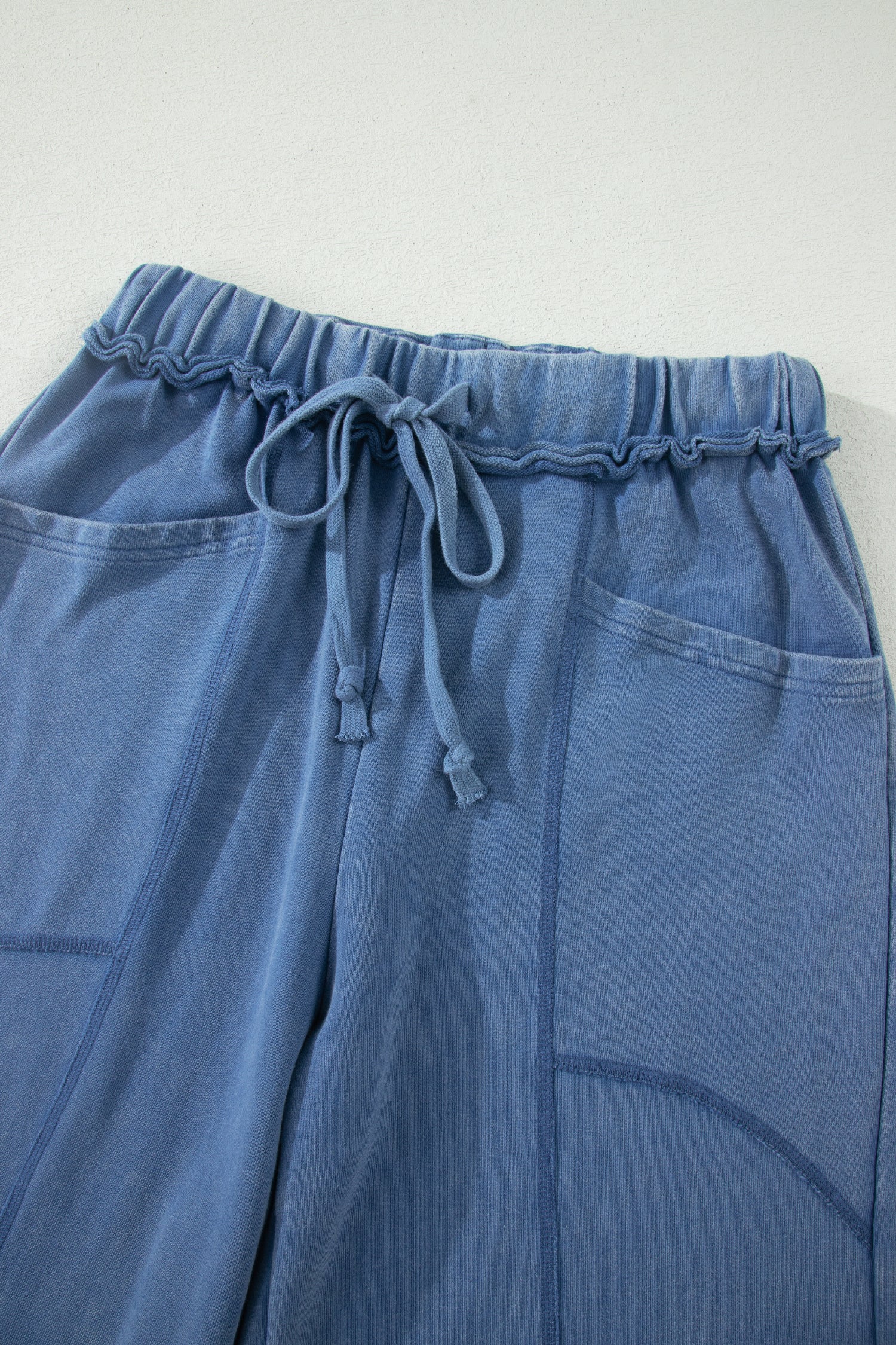 Dusty Blue washed cotton wide leg pants with drawstring waist, oversized patch pockets, and relaxed fit.