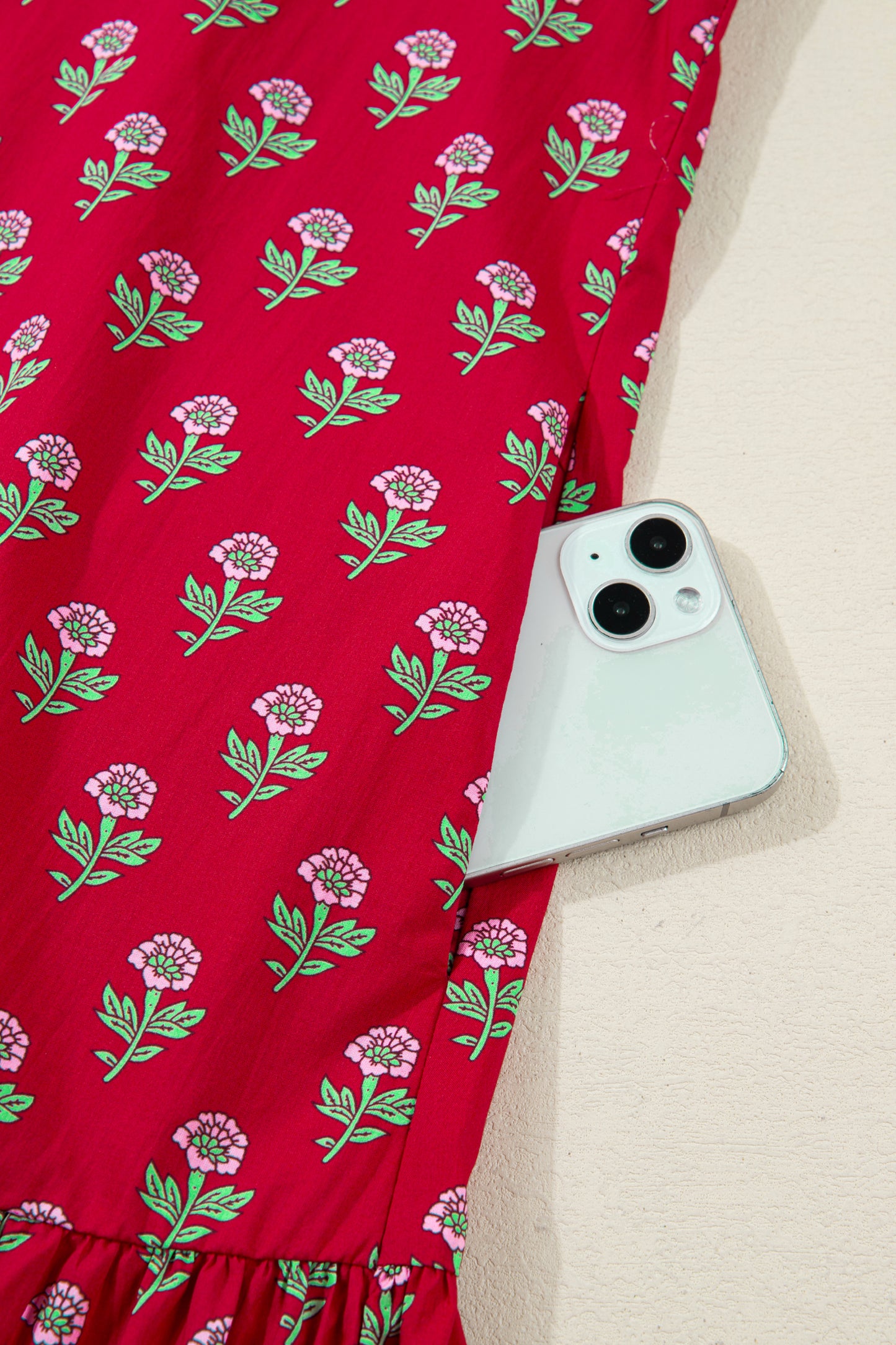 Red floral mini dress with pink collared neckline, mint scalloped trim, short puff sleeves, and a ruffled drop-waist hem