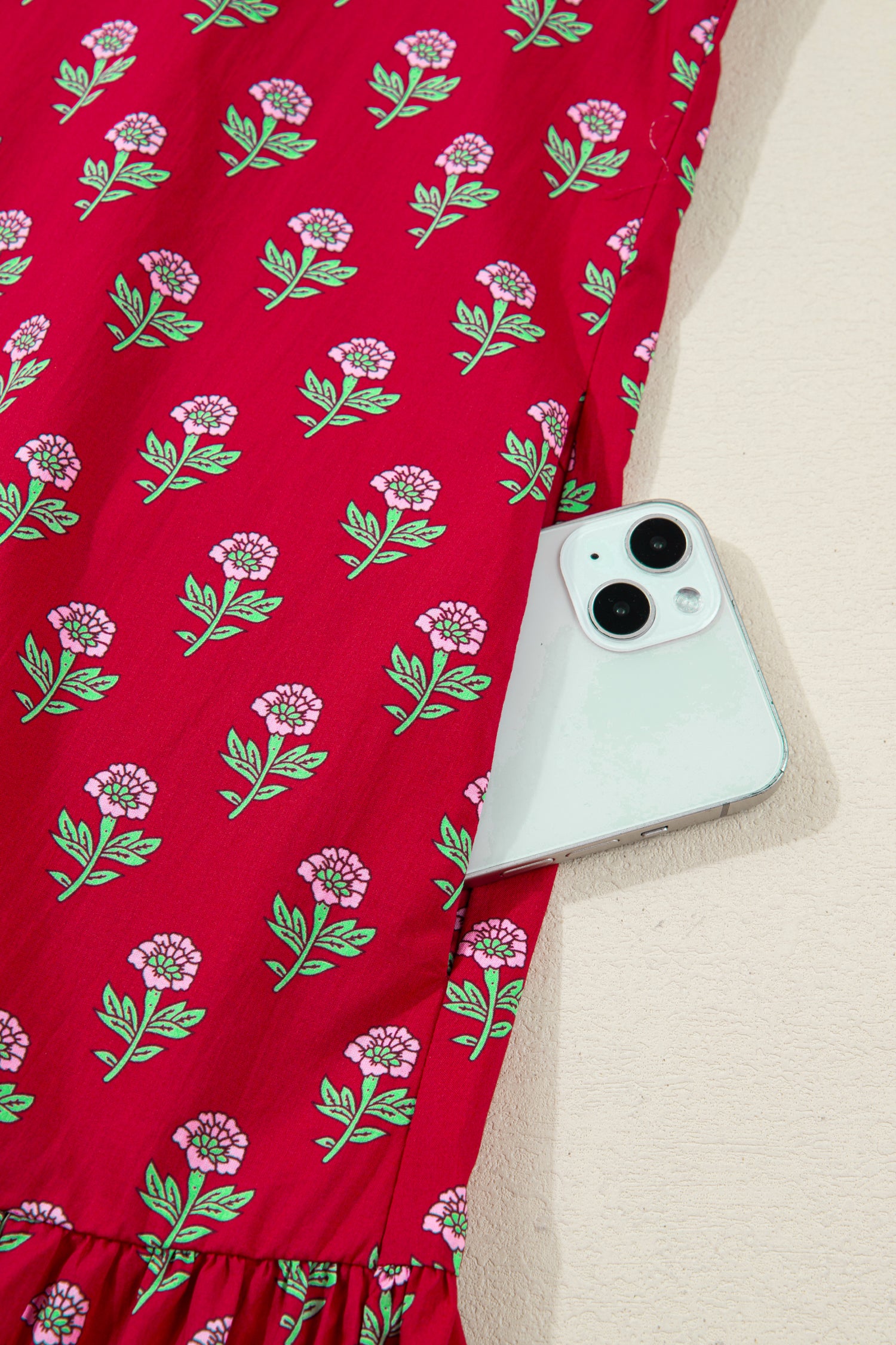 Red floral mini dress with pink collared neckline, mint scalloped trim, short puff sleeves, and a ruffled drop-waist hem