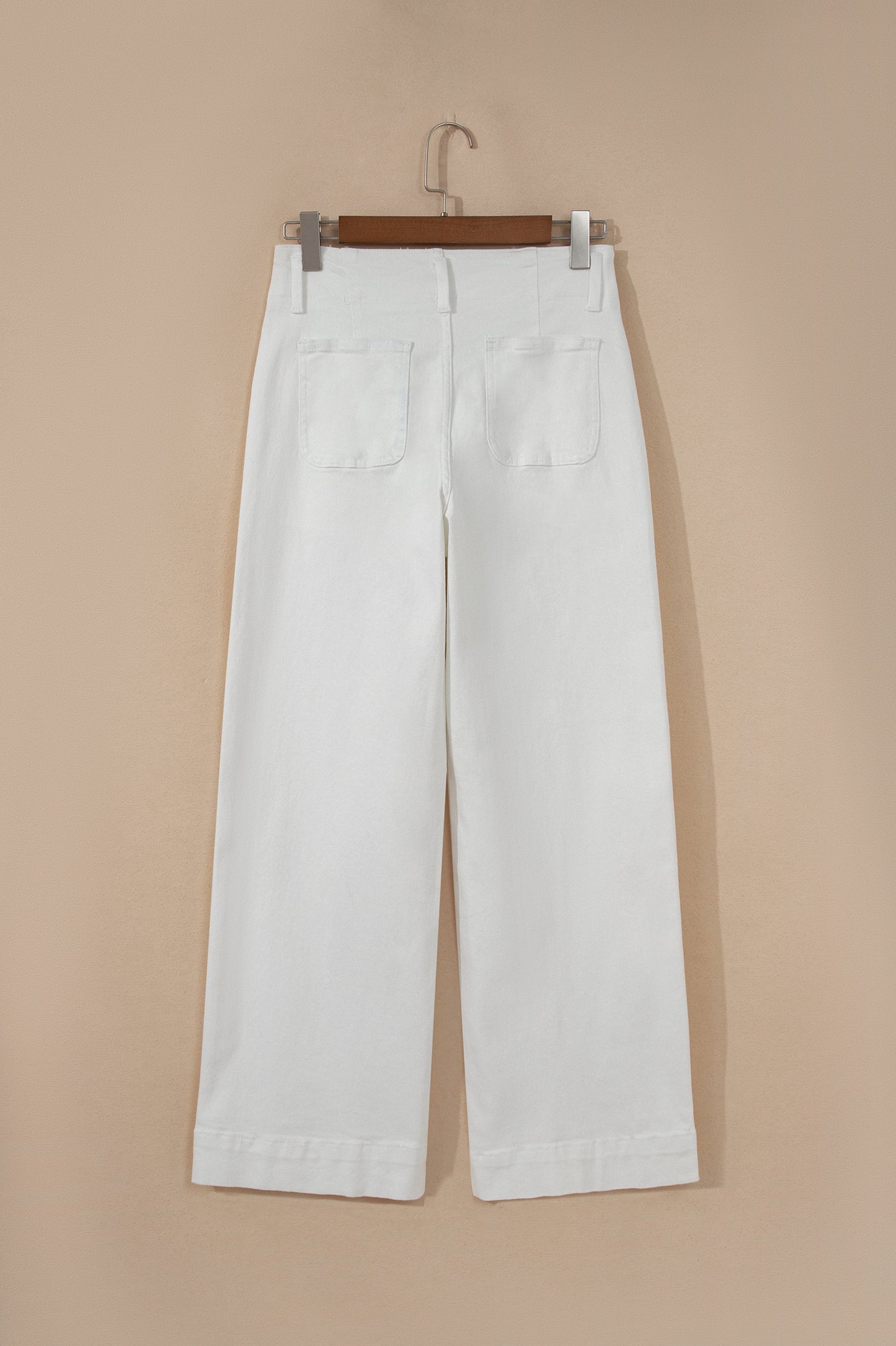 White high rise wide leg jeans with double-button waistband, front pockets and cropped hem.