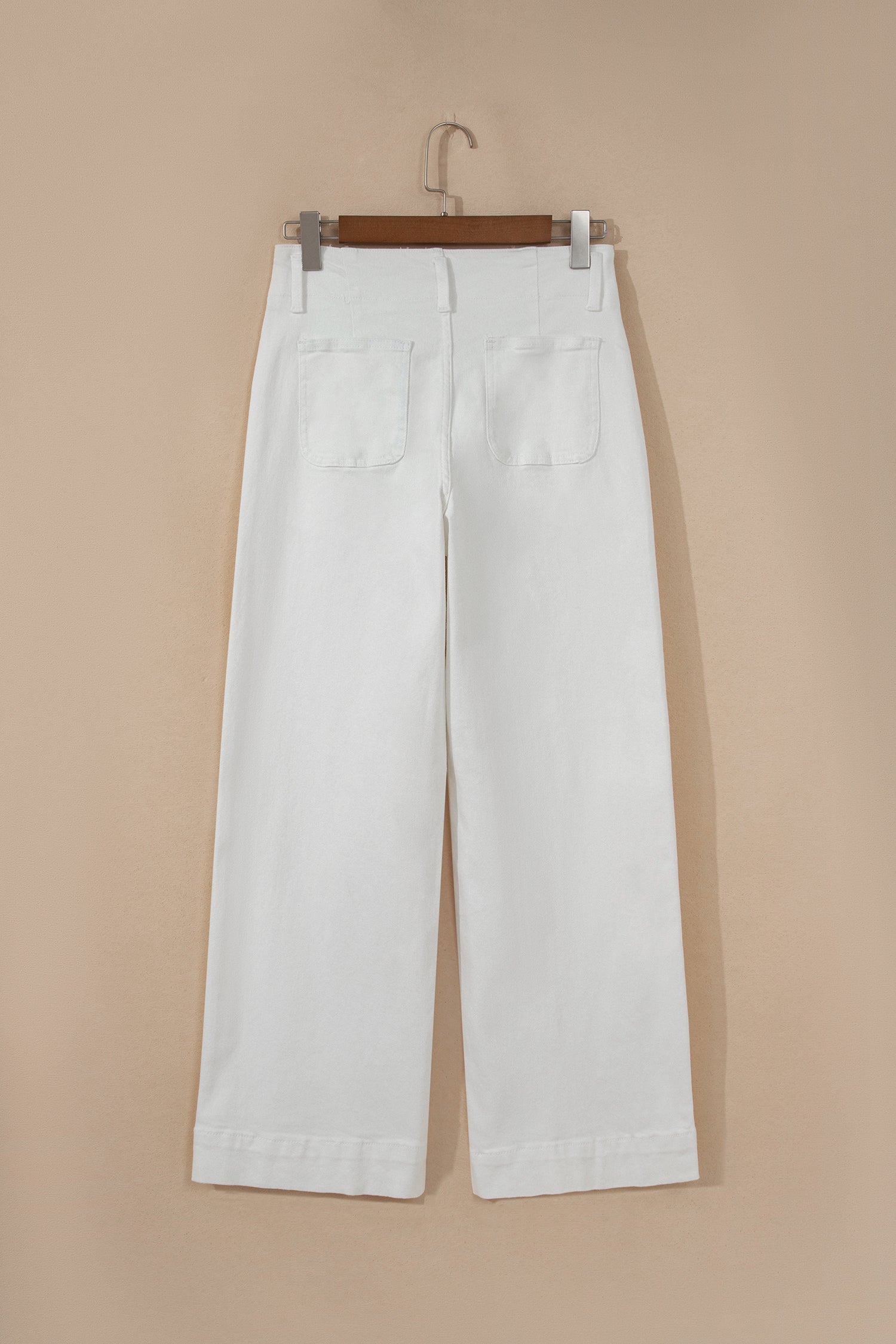 White high rise wide leg jeans with double-button waistband, front pockets and cropped hem.