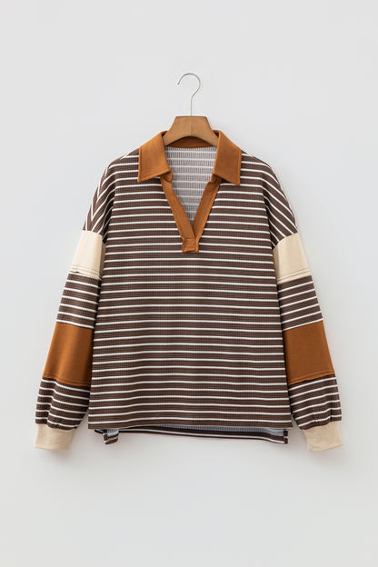 Cocoa Caramel and ivory striped colorblock pullover with a collared V-neckline, dropped shoulders, and long paneled sleeves.