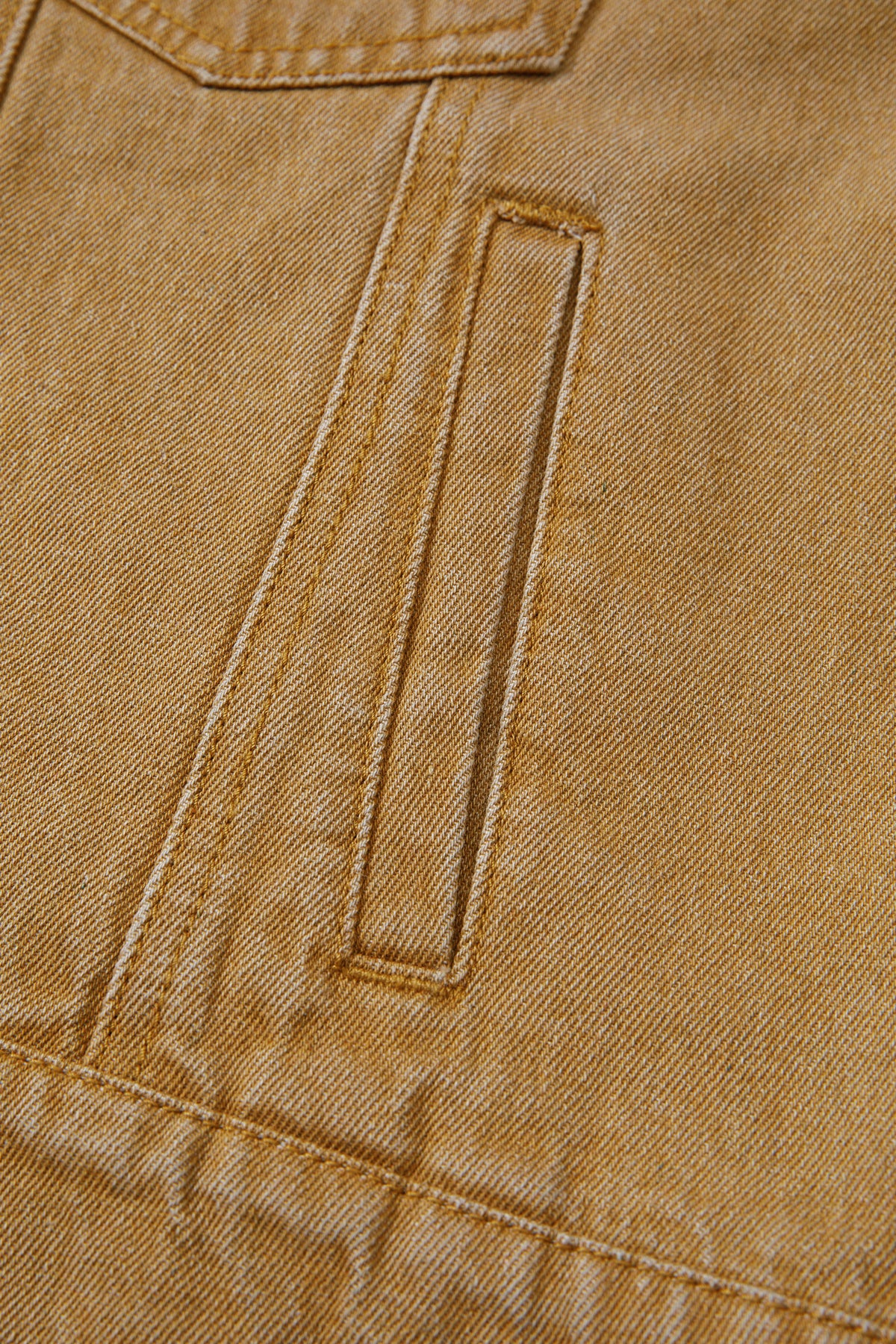 Tan women's denim jacket with metal button front, collared neckline, long sleeves, patch pockets, and relaxed fit.