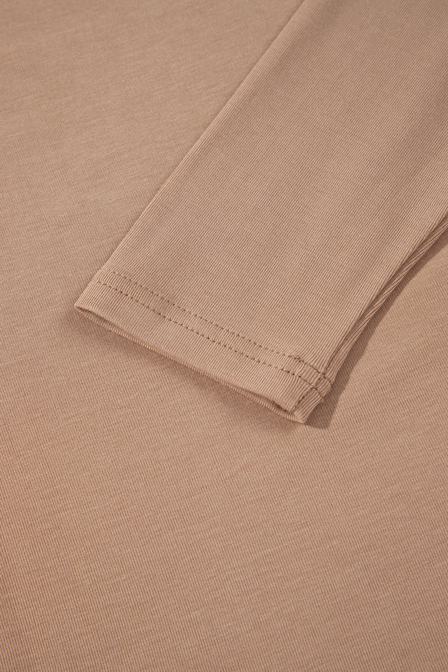 Warm taupe fitted high neck long sleeve top with a smooth stretch-knit finish and regular-length hem.