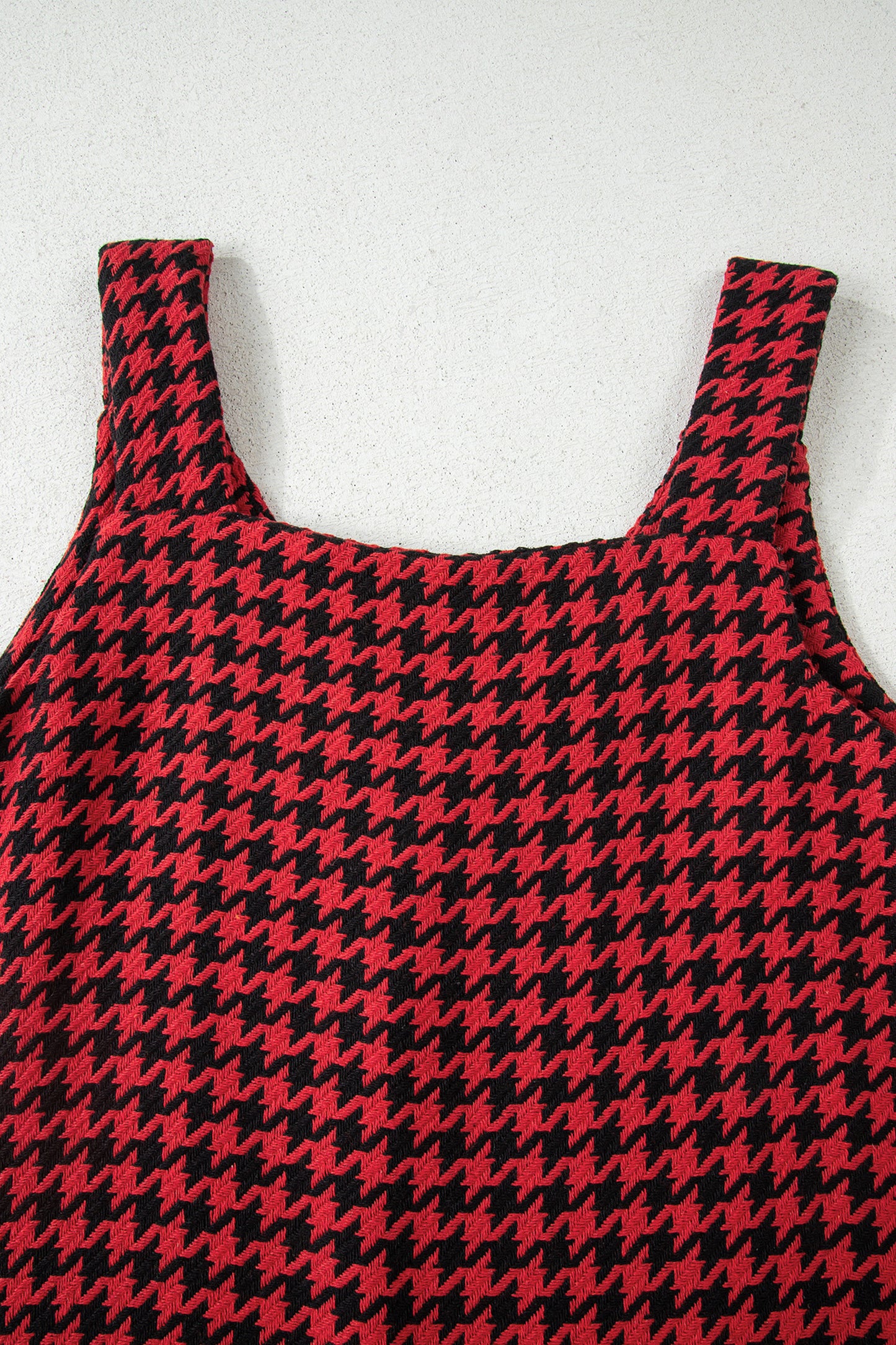 Red textured houndstooth jacquard sleeveless mini dress with V-neckline and A-line silhouette.