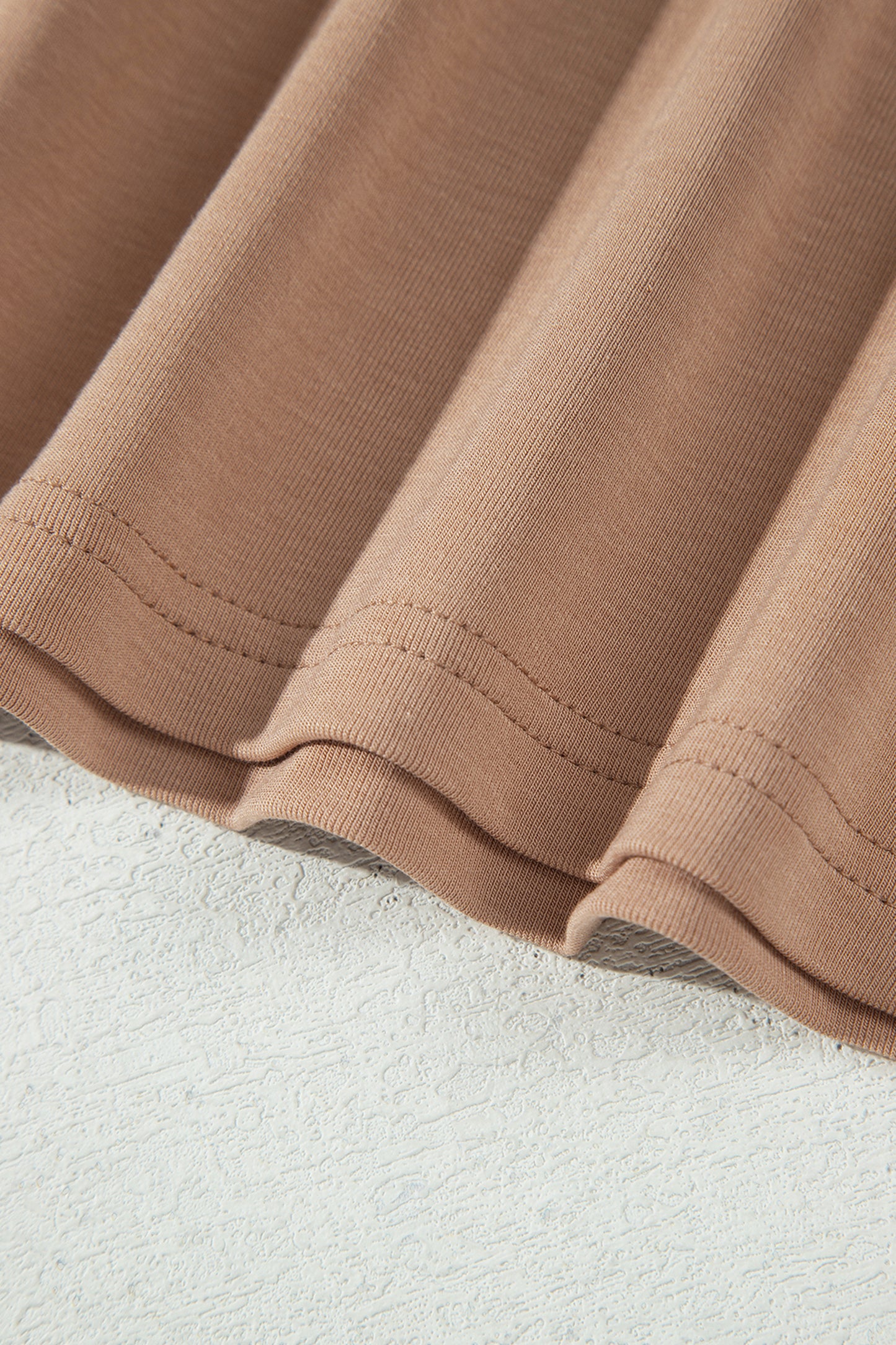 Warm taupe fitted high neck long sleeve top with a smooth stretch-knit finish and regular-length hem.