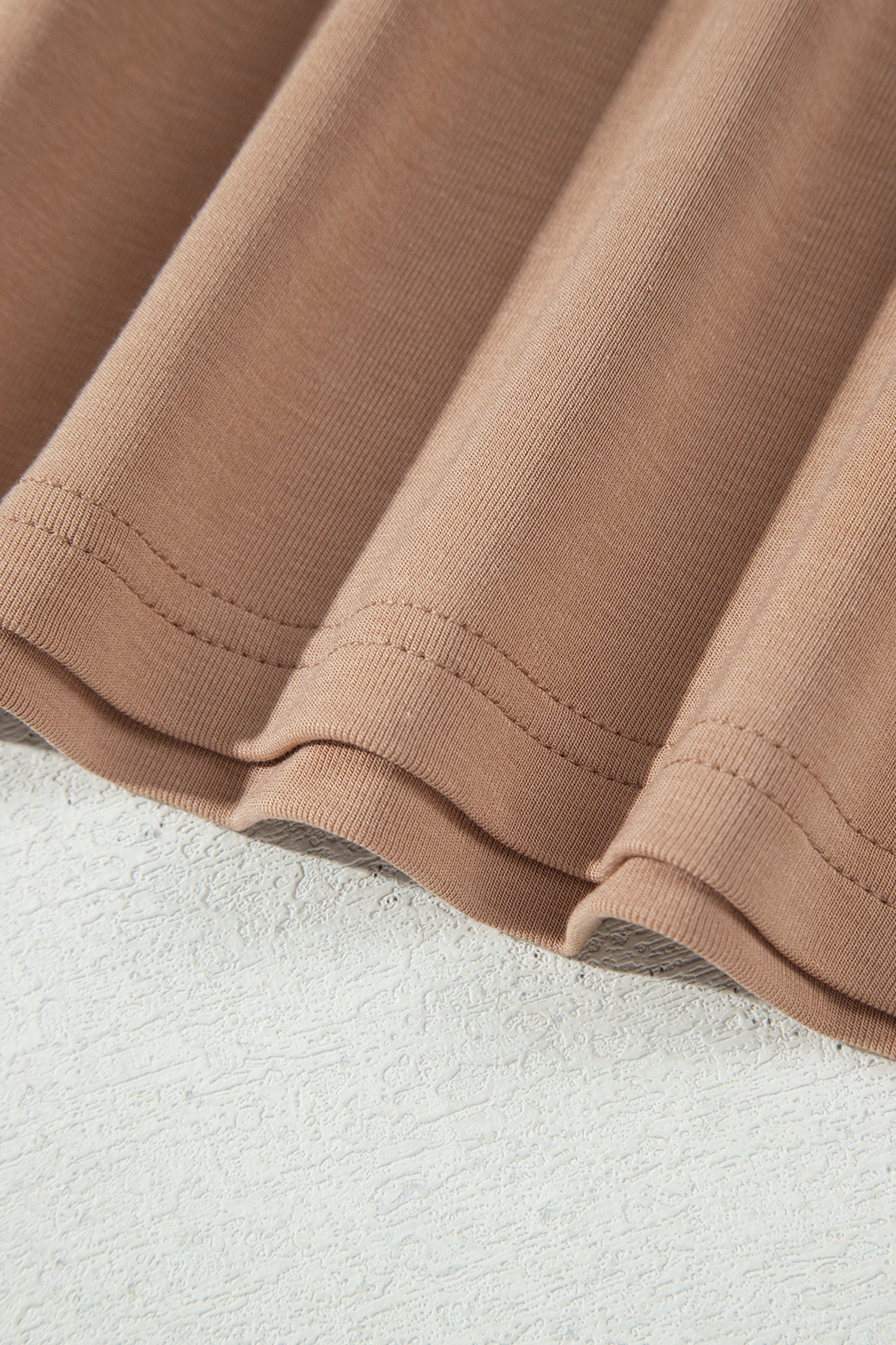 Warm taupe fitted high neck long sleeve top with a smooth stretch-knit finish and regular-length hem.
