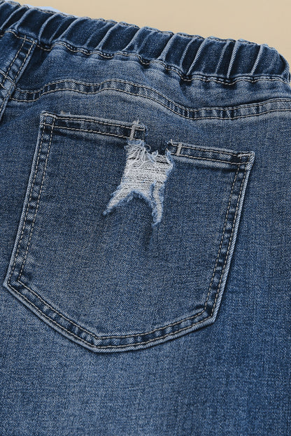 Medium wash blue distressed slim straight leg jeans with drawstring elastic waist and raw hem