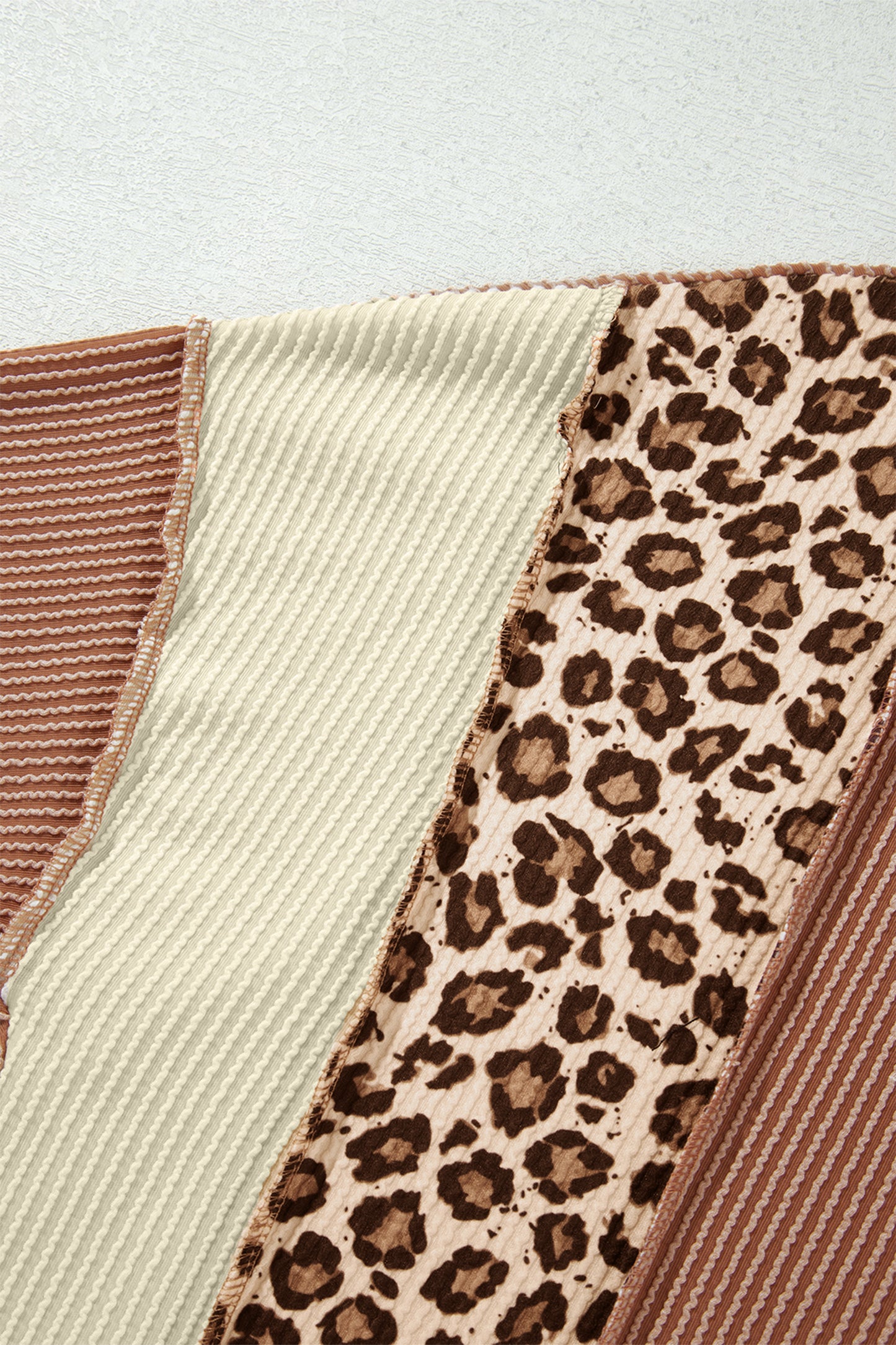 mocha brown leopard colorblock ribbed knit top with a round neckline, dropped shoulders, relaxed fit, and long sleeves.
