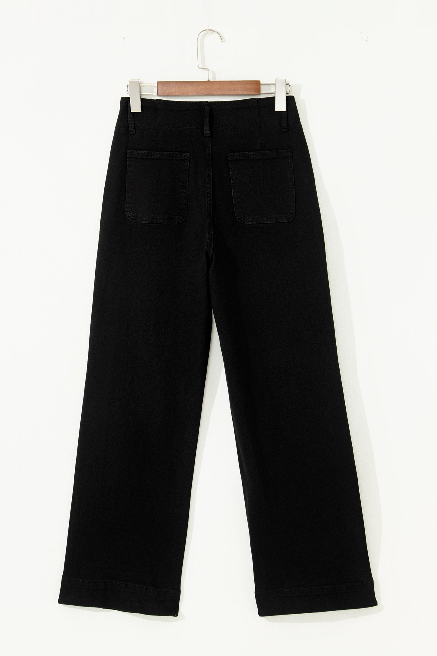 Black high rise wide leg jeans with double-button waistband, front pockets and cropped hem.