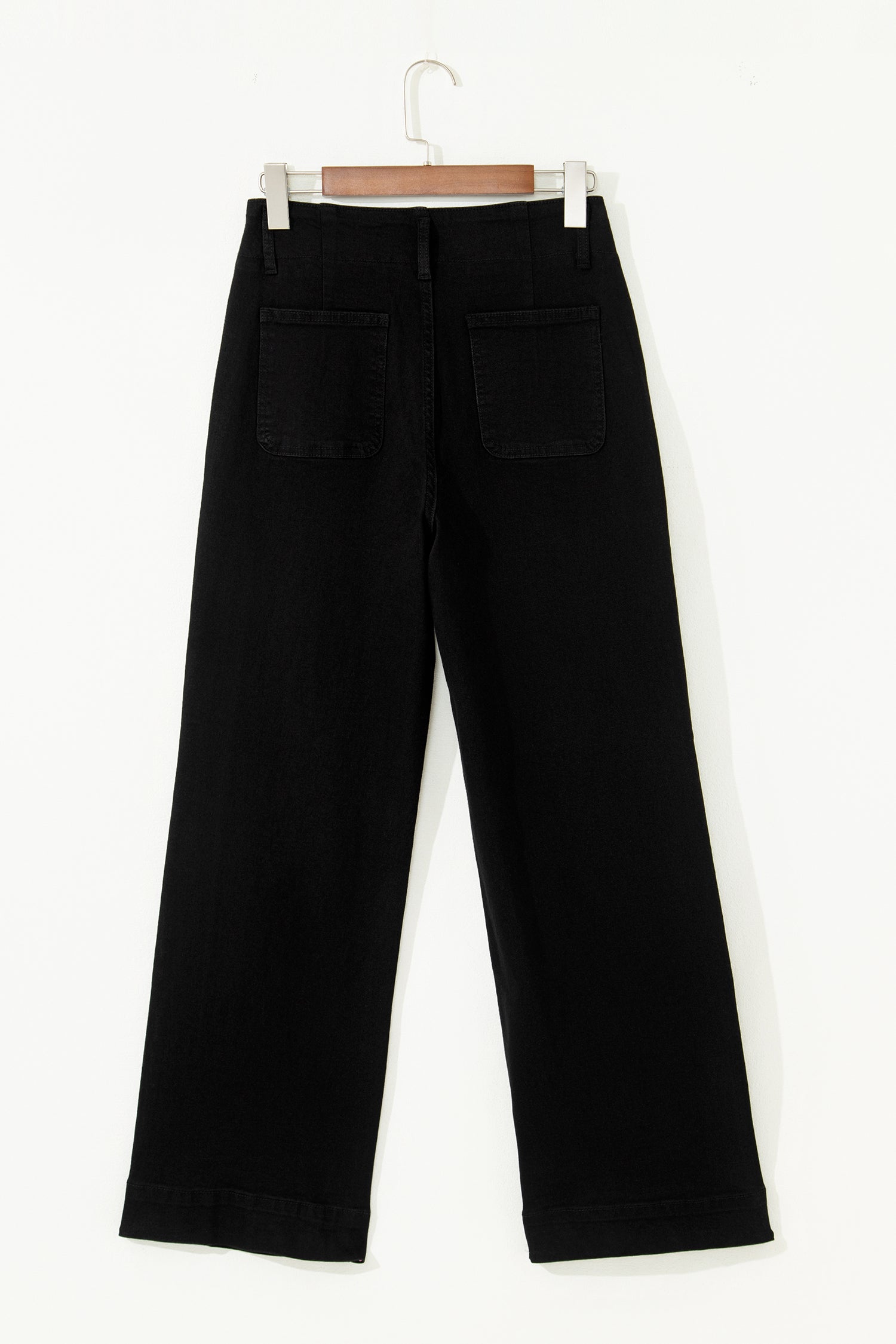 Black high rise wide leg jeans with double-button waistband, front pockets and cropped hem.