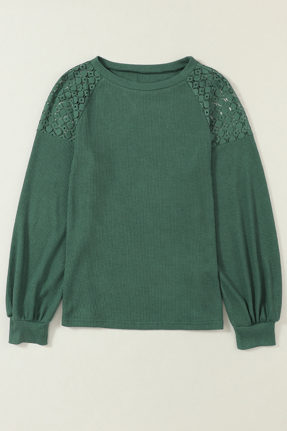 Forest green waffle knit long sleeve top with floral lace shoulder panels, crew neckline, relaxed fit, and balloon sleeves.