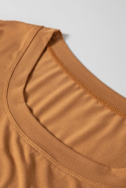Woman wearing a Caramel Mocha scoop neck long sleeve top with a soft casual fit and white pants.