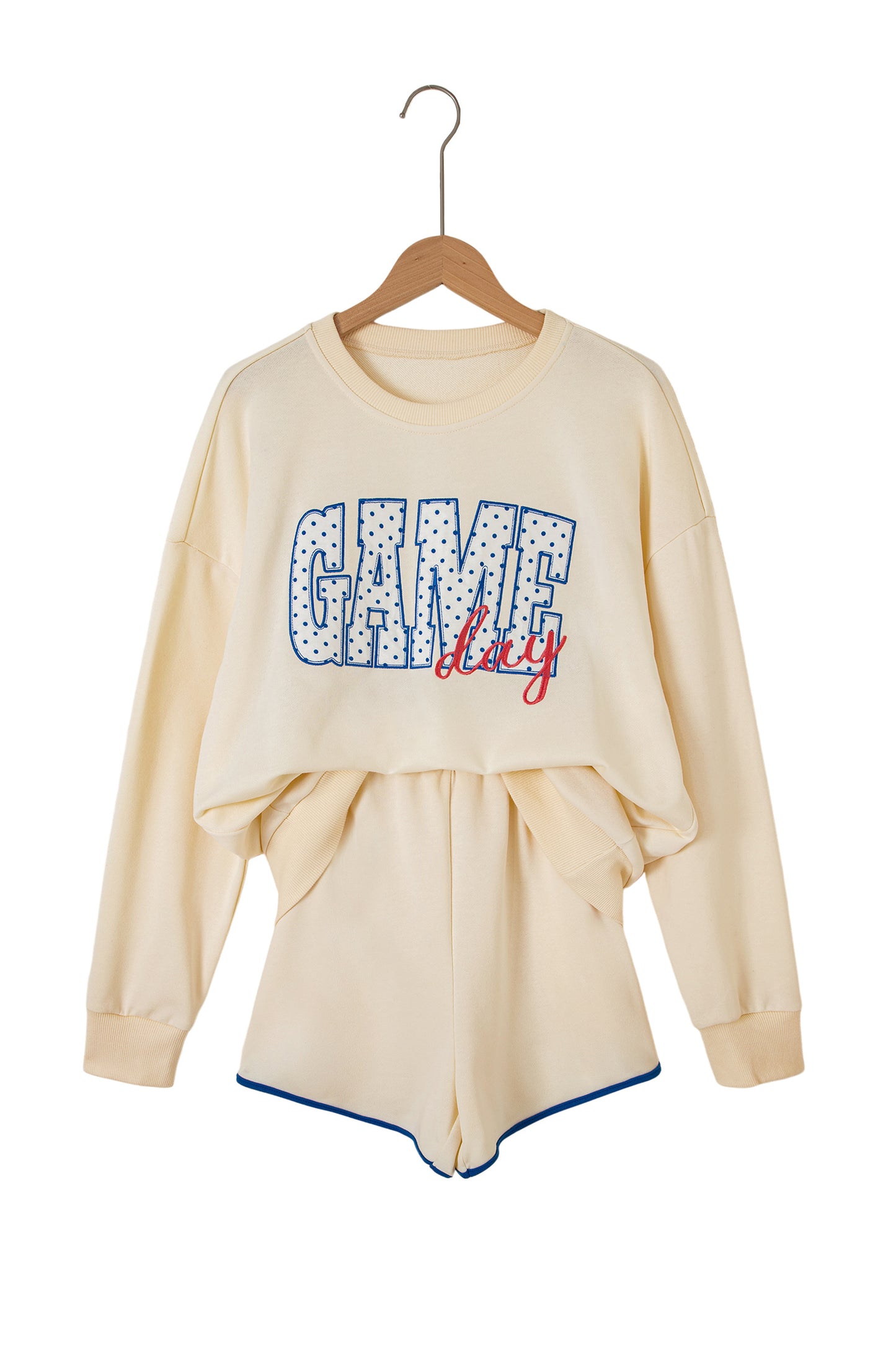 Cream Game Day embroidered sweatshirt and matching drawstring shorts set featuring long sleeves, blue contrast trim, relaxed fit, and casual sporty style.