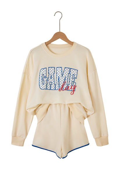 Cream Game Day embroidered sweatshirt and matching drawstring shorts set featuring long sleeves, blue contrast trim, relaxed fit, and casual sporty style.