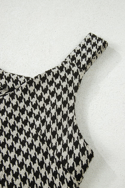 Black textured houndstooth jacquard sleeveless mini dress with V-neckline and A-line silhouette.