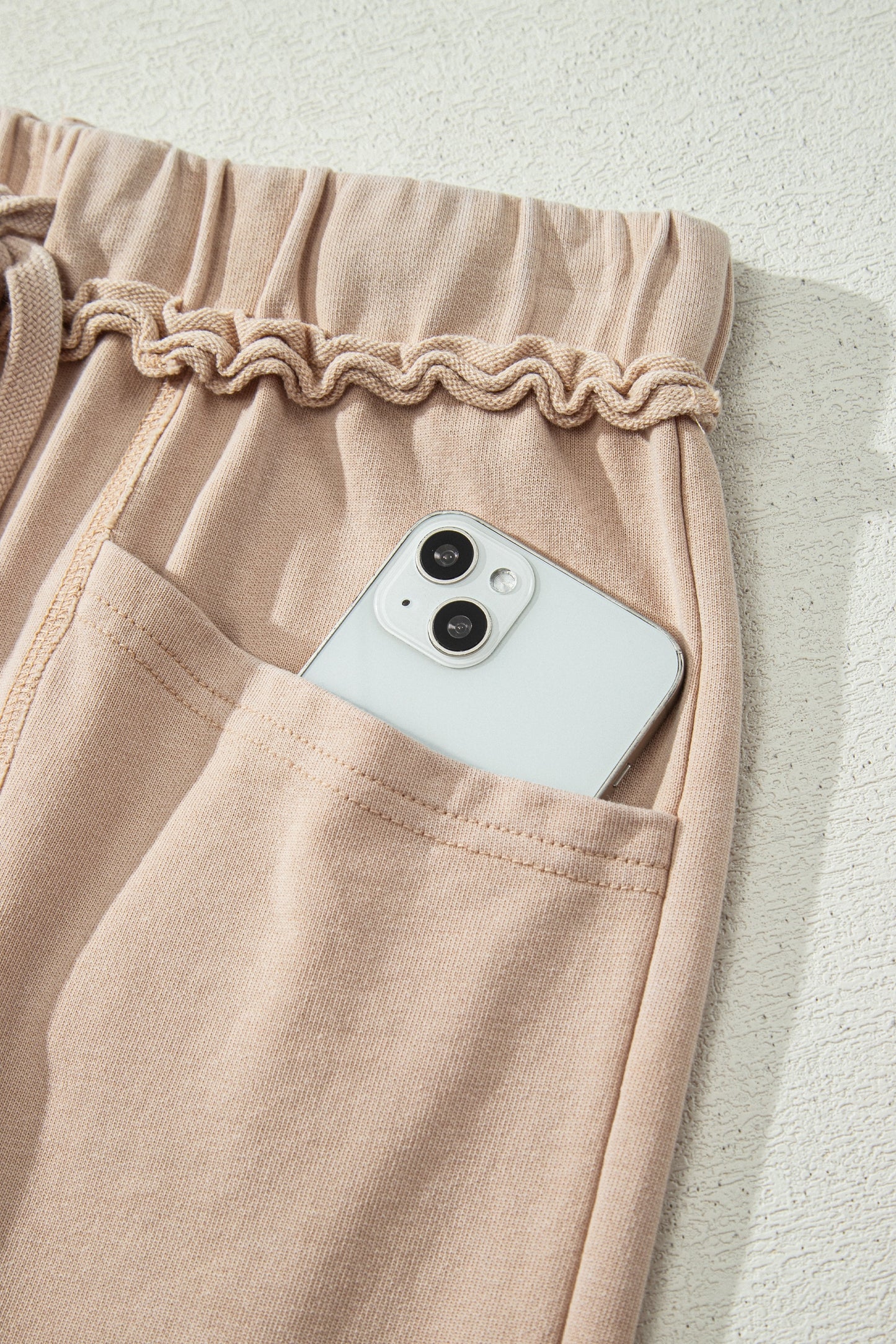 Sand washed cotton wide leg pants with drawstring waist, oversized patch pockets, and relaxed fit.