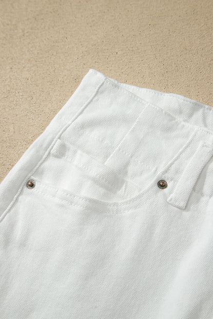 White high rise wide leg jeans with double-button waistband, front pockets and cropped hem.