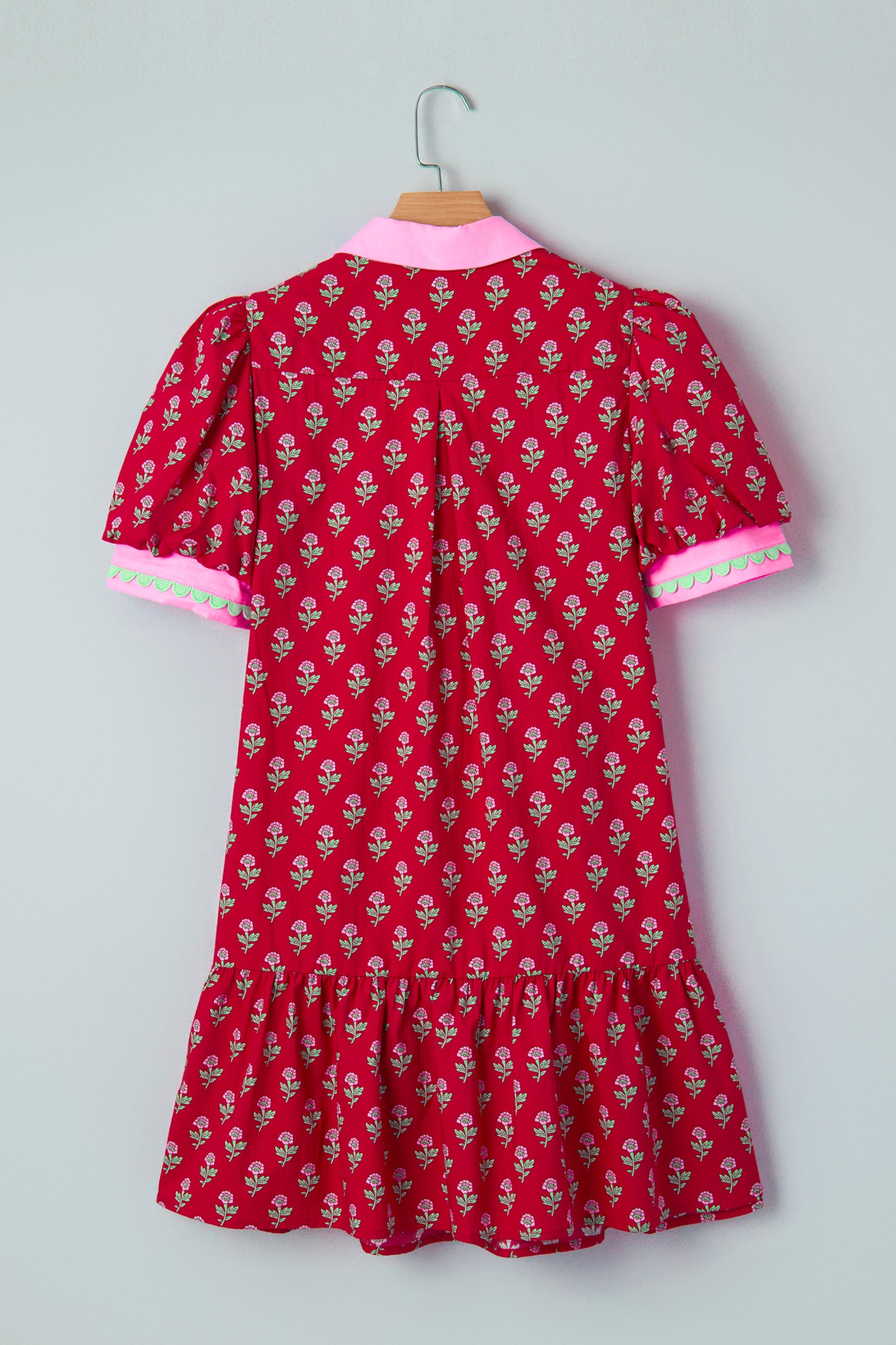 Red floral mini dress with pink collared neckline, mint scalloped trim, short puff sleeves, and a ruffled drop-waist hem