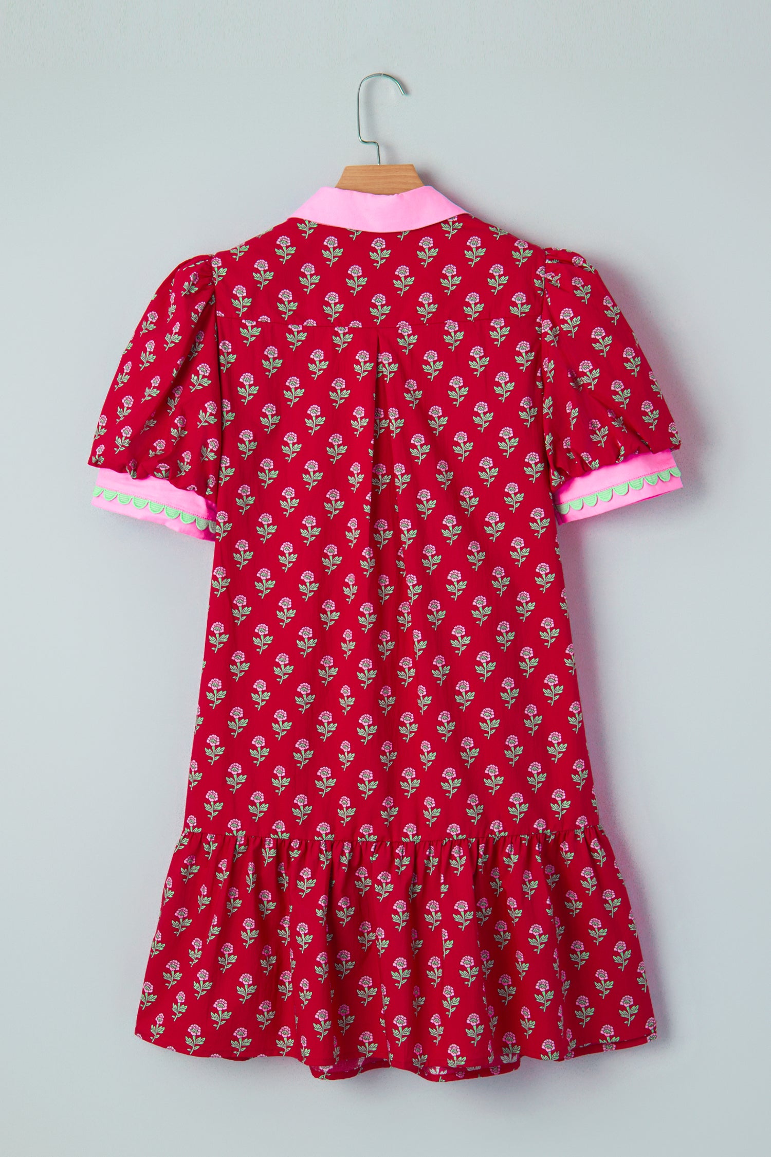 Red floral mini dress with pink collared neckline, mint scalloped trim, short puff sleeves, and a ruffled drop-waist hem