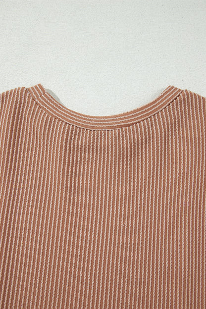 mocha brown leopard colorblock ribbed knit top with a round neckline, dropped shoulders, relaxed fit, and long sleeves.