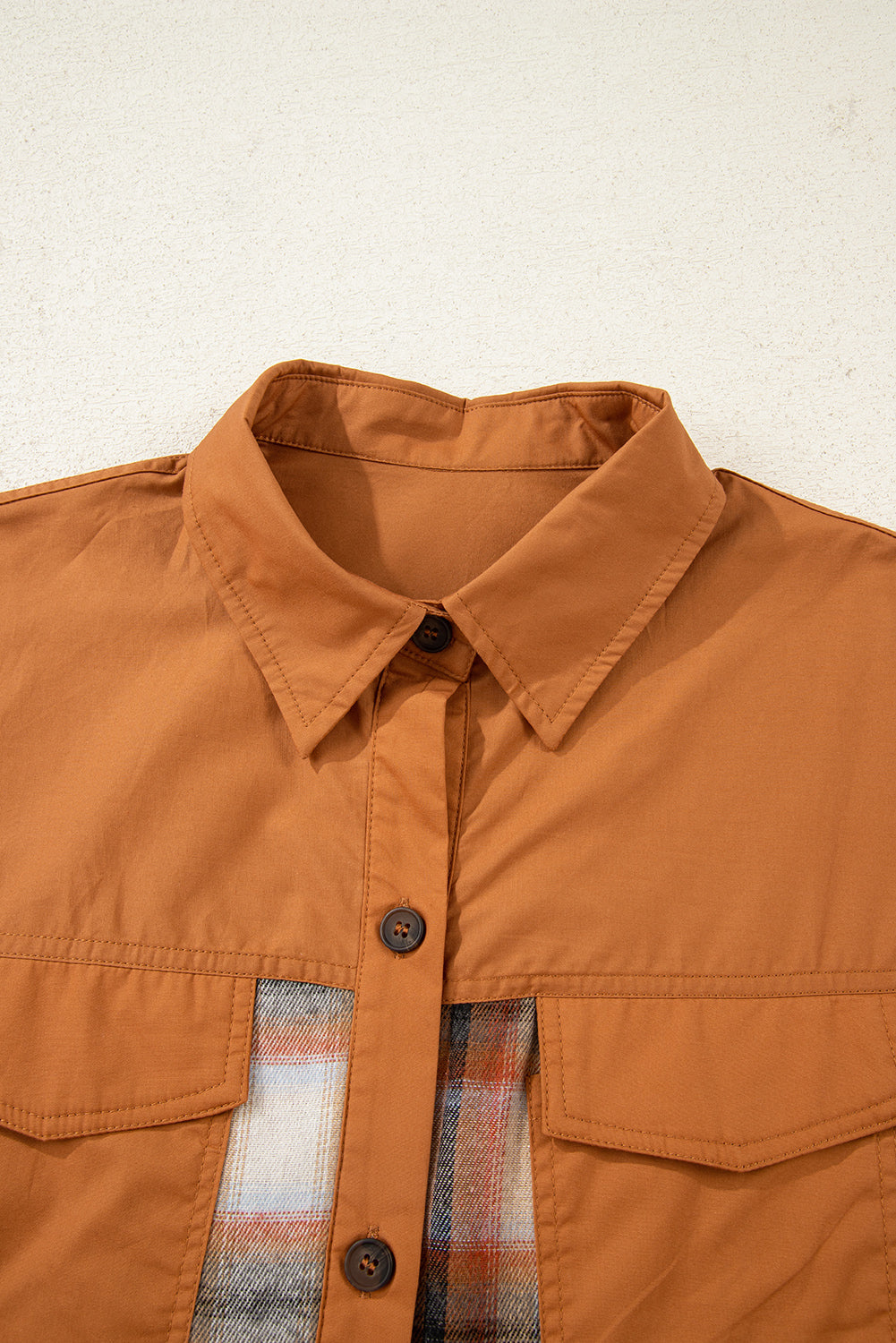 Caramel plaid tunic shirt dress with collared neckline, button front, chest pockets, long sleeves, and relaxed mini silhouette.