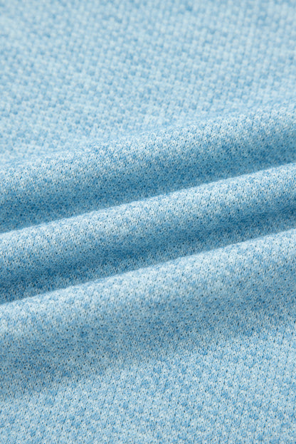 Powder Blue textured raglan long sleeve top with round neckline, relaxed fit, and curved hem