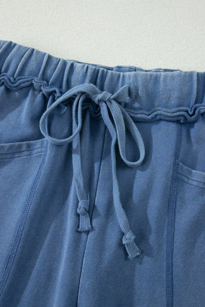 Dusty Blue washed cotton wide leg pants with drawstring waist, oversized patch pockets, and relaxed fit.