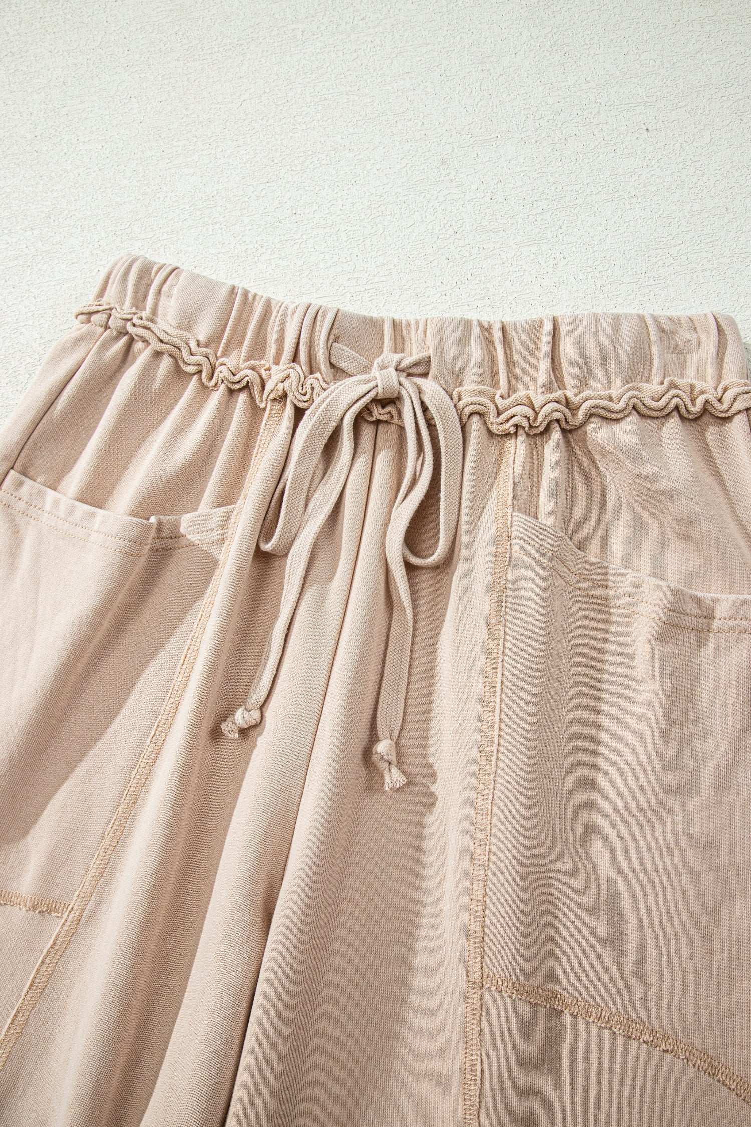 Sand washed cotton wide leg pants with drawstring waist, oversized patch pockets, and relaxed fit.