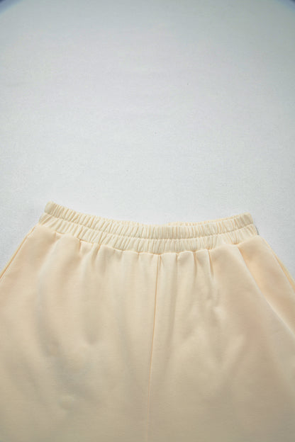 Cream Game Day embroidered sweatshirt and matching drawstring shorts set featuring long sleeves, blue contrast trim, relaxed fit, and casual sporty style.