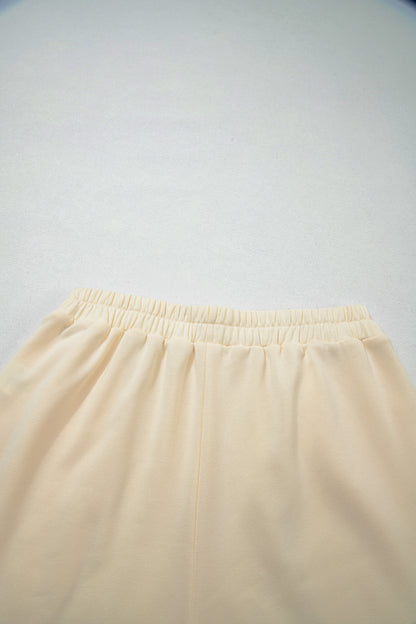 Cream Game Day embroidered sweatshirt and matching drawstring shorts set featuring long sleeves, blue contrast trim, relaxed fit, and casual sporty style.